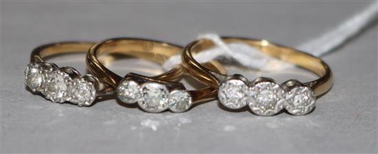 Three gold and three stone diamond rings, two stamped 18ct.
